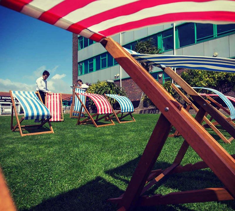 Deck chairs on the lawn at Brighton Racecourse