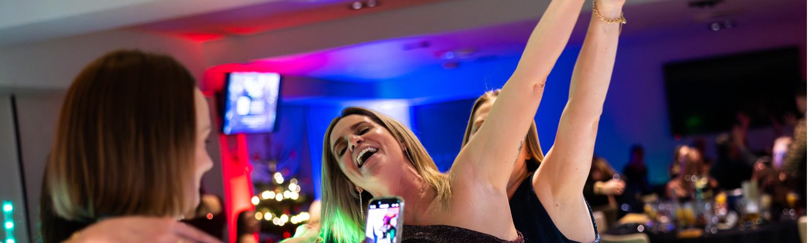 Woman dancing and enjoying herself at Brighton Christmas Party.