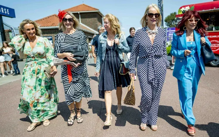 A group of well dressed ladies walk into Brighton Racecourse