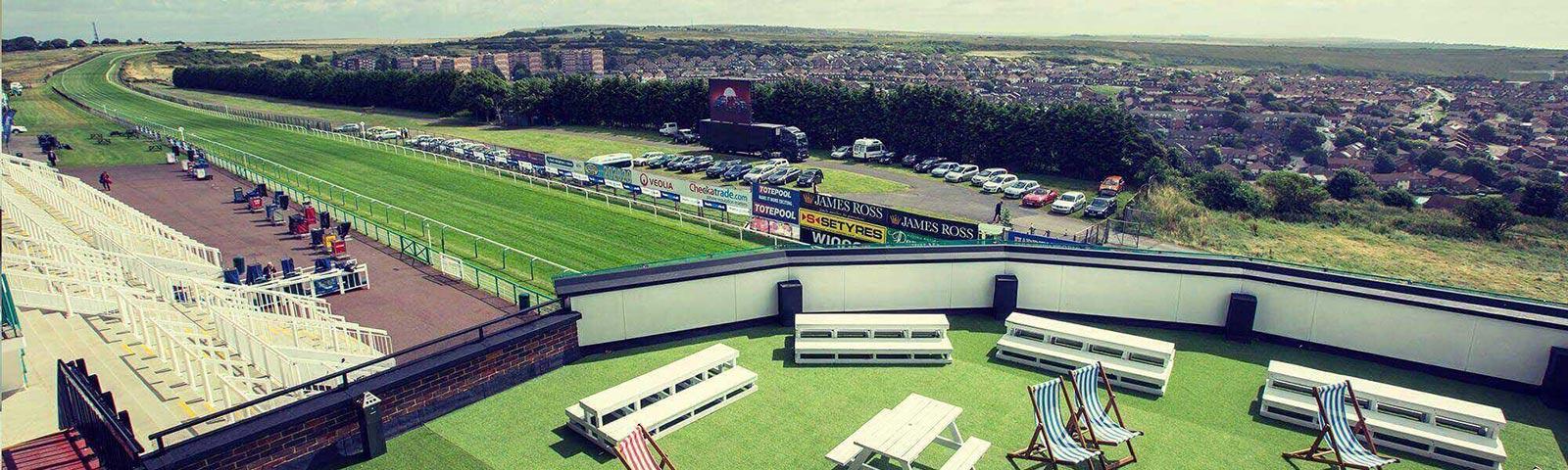 Rooftop picnic area looking down onto the home straight