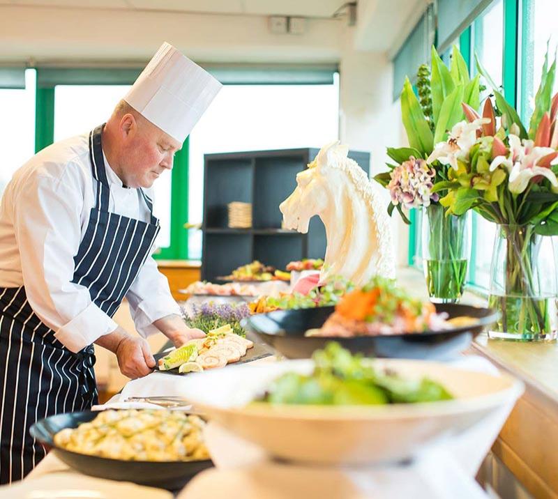 Chef preparing a selection of meals for diners.