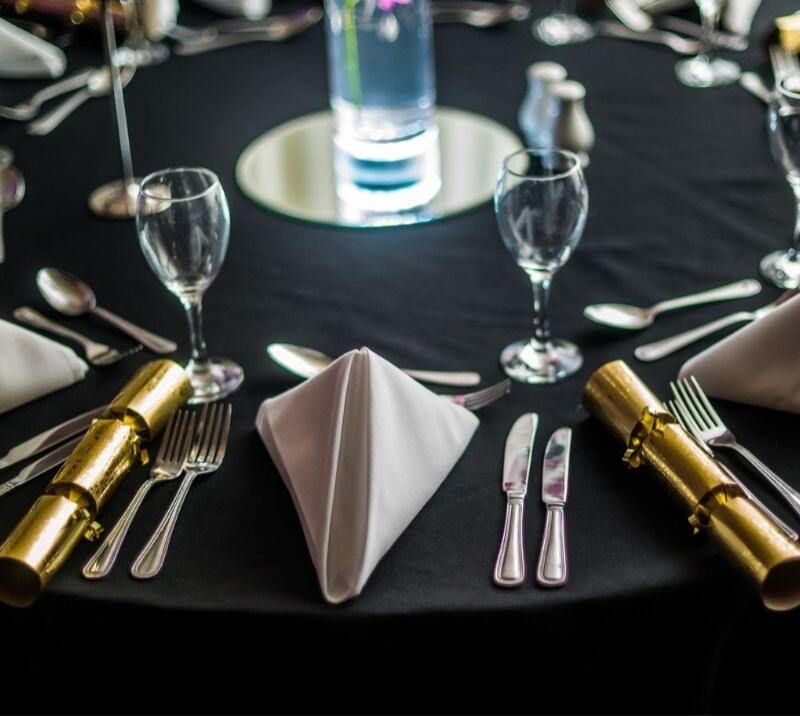 Christmas table setting with gold crackers